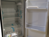an open refrigerator with the door open and the contents in the freezer