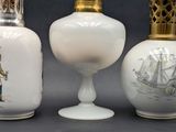 three vases with different designs on them sitting on a table