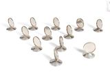 a group of silver colored buttons on a white surface