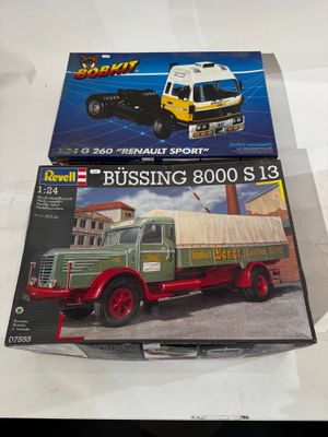 two models of trucks on display on a table