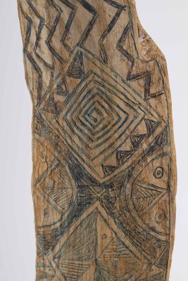 a close up of a piece of wood with a design on it