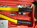 a tool in a red case with a yellow handle