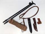 an image of a knife, sheath, and other items laid out on a white surface