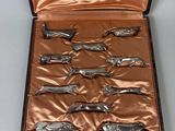 a case with six silver spoons inside of it