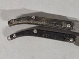 two knives that are sitting next to each other on a table