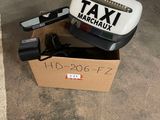 a box with a taxi sign on it sitting on the ground