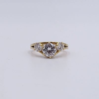 a yellow gold engagement ring with a round brilliant cut diamond