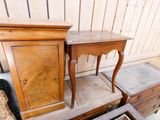 two small tables and a cabinet in a room
