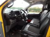 the interior of a yellow truck with black leather seats and a steering wheel