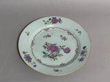 a plate with a flower design on it on a table
