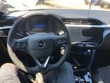 a man sitting in the driver ' s seat of a car