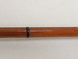 a close up of a wooden stick on a white surface