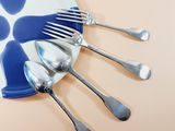 a plate with a bunch of forks and spoons on it