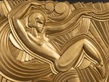 a gold plaque with a woman on it
