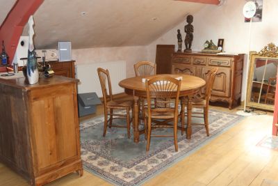 a table and chairs in a room with a rug on the floor