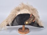 a black hat with a feather on top of it
