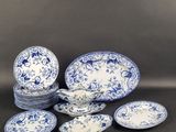 a group of blue and white plates and bowls on a table