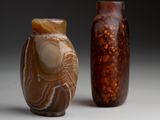two vases sitting next to each other on a table