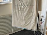 a white board that is on a stand in a room
