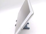 a tablet computer sitting on a stand on a white surface
