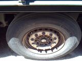 a truck with a flat tire that is parked on the side of the road