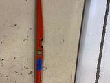 a red tool on the wall next to a window