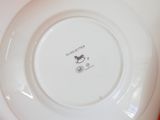 a white plate with a horse on it sitting on a table