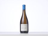 a bottle of white wine sitting on top of a table