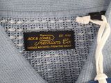 a close up of a blue shirt with a tag on it