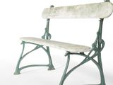 a green bench that is sitting on a white surface