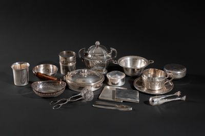 a lot of silverware on a black table