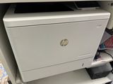 a white printer sitting on top of a white cabinet