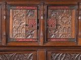 many plates on the top of a wooden cabinet