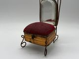 an old wooden chair with a mirror on top of it