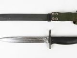 two knives are laying next to each other on a white surface