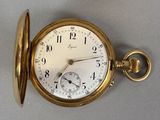 a close up of a pocket watch on a table