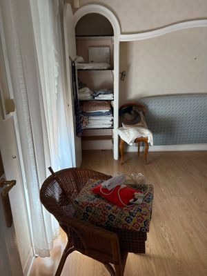 a wicker chair sitting in the corner of a room