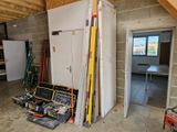 an image of a room with a refrigerator and tools in it