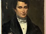 portrait of a man in a black coat with a flower in his lapel