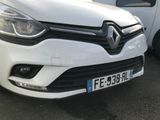 a white car that is parked next to a white van