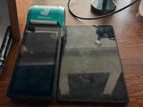 two cell phones sitting on a table next to a cup of coffee