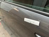 a car with a sticker on it parked on the side of the street