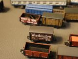 several toy trains are lined up on a table next to each other