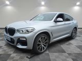 the new bmw x4 suv is parked in a showroom