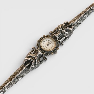 une image d'un gros plan d'une montre-bracelet sur une surface blanche