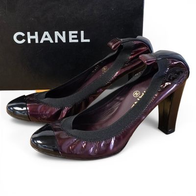 chanel purple patent pumps with black heels and a box