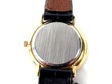 a close up of a watch on a white surface