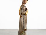 a statue of a man in a robe holding a staff