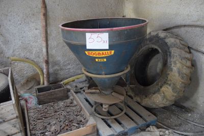 a blue bucket sitting on top of a pallet next to a pile of dirt