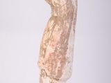 a sculpture of a woman that is standing on a table